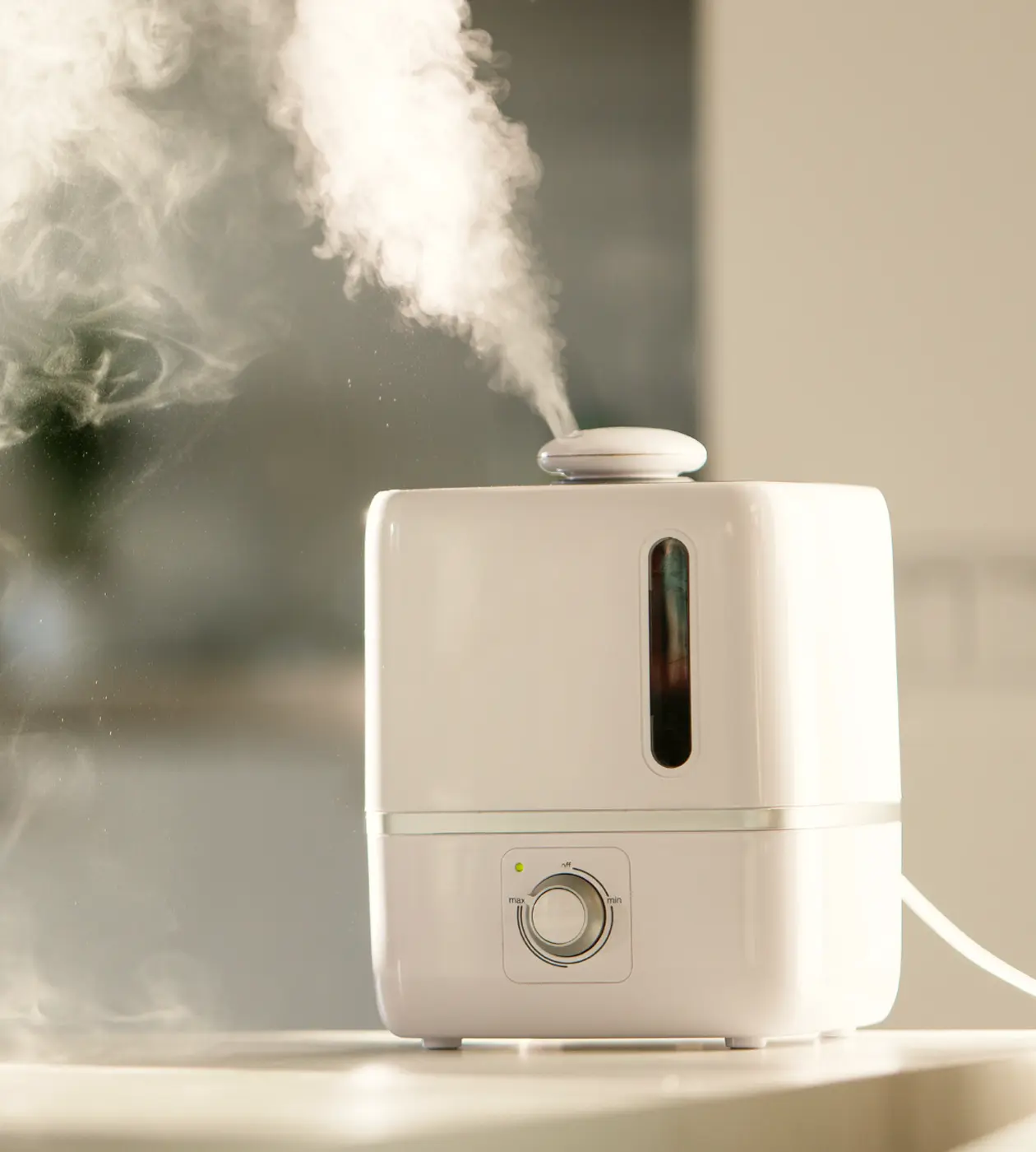 A white humidifier emitting a soft white light, designed for enhancing indoor air quality and comfort.